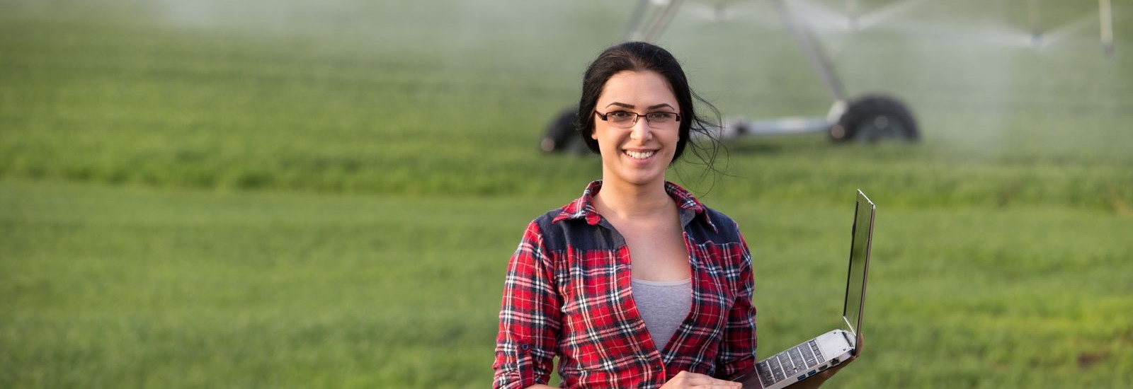 Farmer woman with irrigation equipment in field